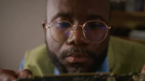 Close-up of Technician with Glasses Inspecting Computer Graphics Card Stock Footage 341426226