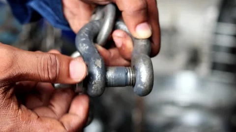 Close up technician hand holding and release the shackle pins Stock Footage 310176147