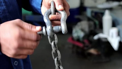 Close up technician hand holding and tighten the shackle pins Stock Footage 310176154