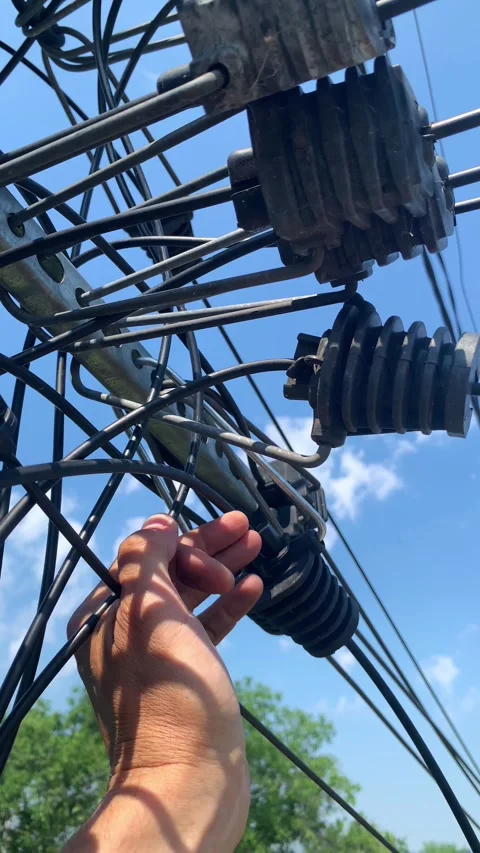 Close-up of technician hand holding fiber optic connector on utility cables. Video stock 346298764