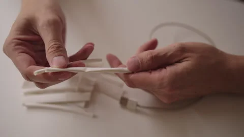Close-up of technician hands applying heat shrink tubing to damaged charging Stock Footage 317541978