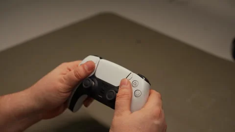 Close-up of technician hands examine broken white and black wireless game Stock Footage 307447225