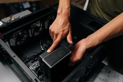 Close-up of technician hands installing CPU water cooler into desktop computer Stock Photos