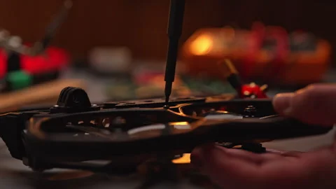 Close-up of technician hands using screwdriver to assemble and repair first 動画素材 302568793