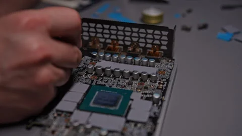 Close-up of technician man meticulously applying new thermal pad to graphics Stock Footage 293741320