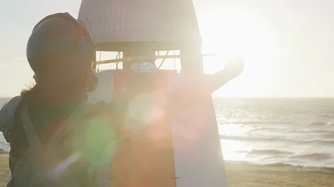 Close-up of technician measuring the spaceshuttle model on the beach Stock Footage 108963612
