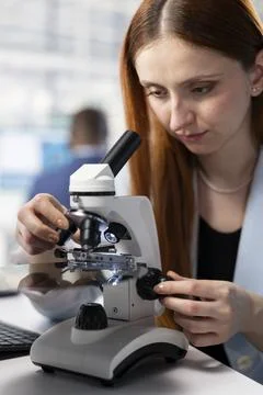Close up of technician in RD office analyzing microelectronics with microscope Stock Photos