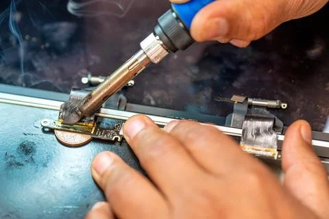 Close-up of technician repairing computer connector using precision tools i.. Stock Photos