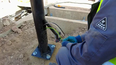 Close up of a technician routing electrical wires through a steel support Stock Footage 342467272