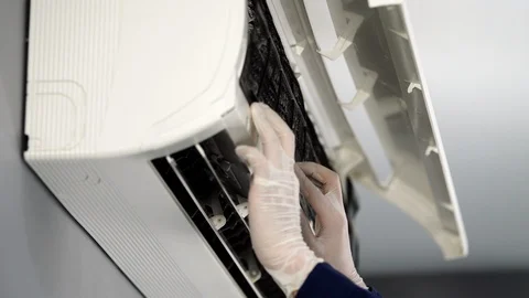 Close up technician service placing back clean filter into air conditioner Video stock 115466193