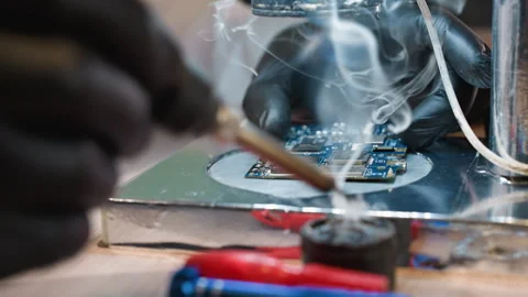 Close-Up of Technician Soldering Circuit Board Under Microscope Stock Footage 282301257