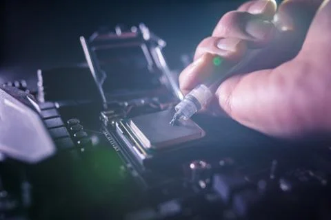 Close up to technician squeezing or application the thermal paste compound on Stock Photos