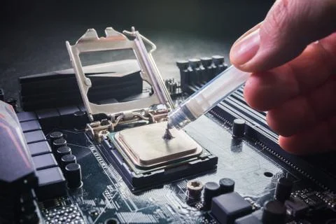 Close up to technician squeezing or application the thermal paste compound on Stock Photos