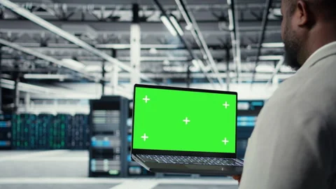 Close up of technician using green screen laptop in data center Stock Footage 311896852