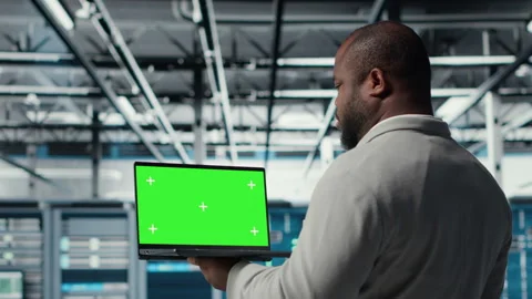 Close up of technician using green screen laptop in data center Stock Footage 311959848