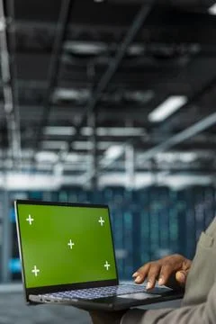 Close up of technician using green screen laptop in data center Stock Photos
