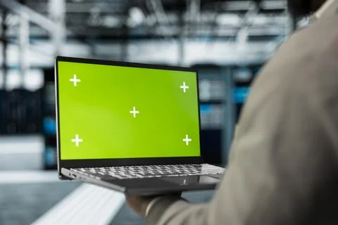 Close up of technician using green screen laptop in high tech data center Stock Photos