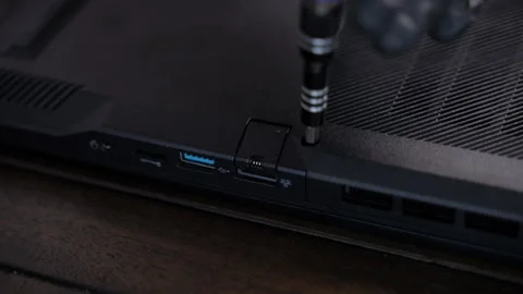 Close-up of a technician using a screwdriver to open computer back cov Stock Footage 326085955