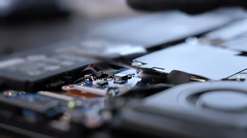 Close-up of a technician using a screwdriver to repair an electronic d Stock Footage 326181509