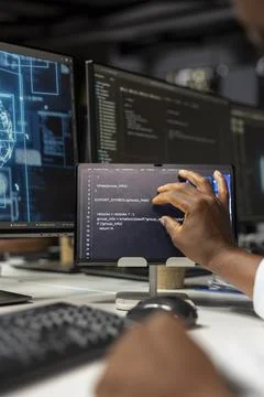 Close up of technician using tablet in office, reviewing AI system metrics 库存照片