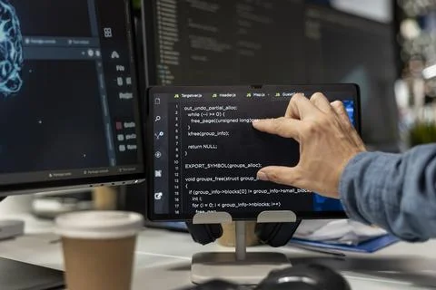 Close up of technician using tablet in startup office, coding machine learning Stock Photos