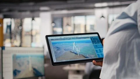 Close up of technician using tablet to work on futuristic wind turbine Stock Photos