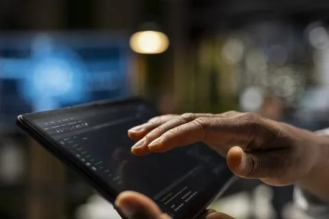 Close up of technician using tablet to write code, developing deep learning APIs 스톡 사진