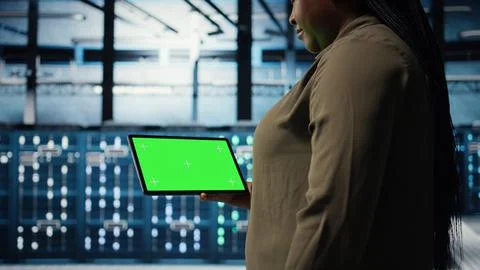 Close up of technician at work using green screen tablet in data center Stock Photos