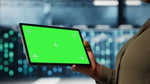Close up of technician at work using green screen tablet in data center Foto stock