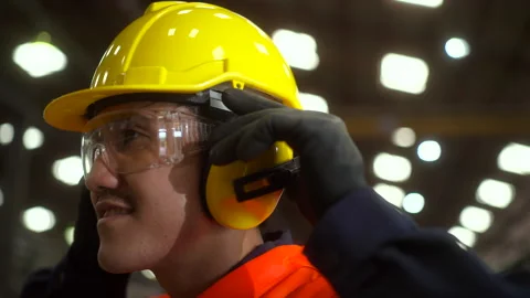 Close up technician worker wearing and adjust  ear protection, protective headph Stock Footage 287474933
