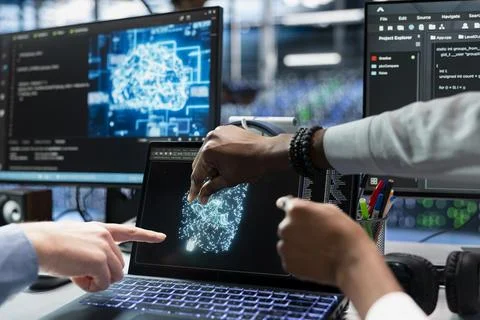 Close up of technicians coding in data center, updating AI automation scripts Stock Photos