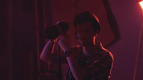 Close-up of technicians in the filmmaking lighting the lamp and smiling to the Stock Footage 130657236