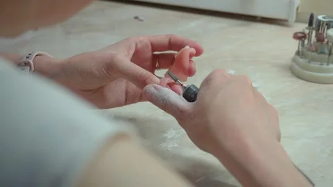 Close-up of technician's hand working on dentures. 4K Stock Footage 304505955