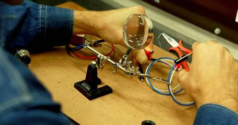 Close-up of a technician's hands working on electronics in an office Fotos de archivo