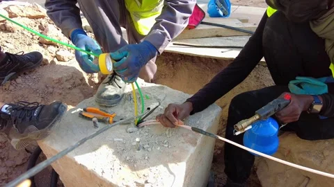 Close up of technicians using electrical tape and a heat torch tool on cables Stock Footage 342467263
