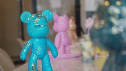 A close-up of a teddy bear figurine, painted with epoxy paint and covered in Stock Footage 306590960