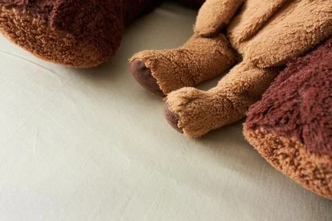 Close up of teddy bear lying on the bed with copy space Stock Photos