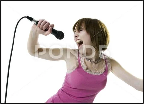 Close-up of a teenage girl singing into a microphone Stock Photos