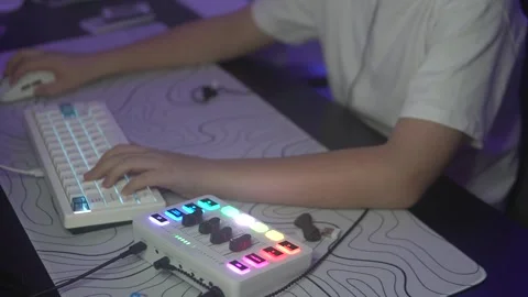 Close-up of teenage hands on glowing computer keyboard in dark room, concept boy Stock Footage 304867173