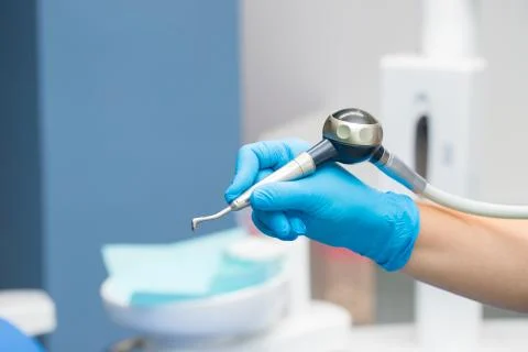 Close-up teeth airflow tool in the hand. Stock Photos