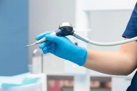 Close-up teeth airflow tool in the hand. Stock Photos