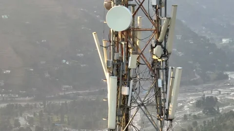Close up of telecom tower antennas over mountain river valley Stock-Footage 348469461