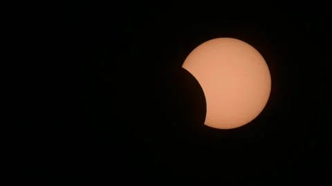 Close-up telephoto view of a partial solar eclipse Stock Footage 346323707