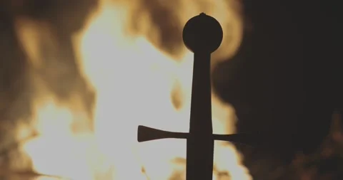 Close-up Templar sword silhouetted by raging fire #1 Stock Footage 150128228