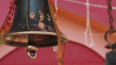 Close Up of Temple Bell Hanging During Hindu Worship Rituals Stock Footage 336884473