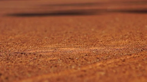 Close up of a tennis ball bouncing off a clay tennis court Video stock 234340223