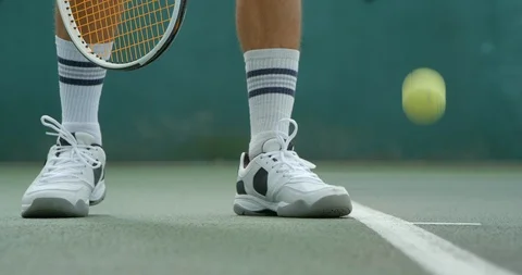 Close up of a tennis player getting ready to serve in slow motion. Video stock 115974833