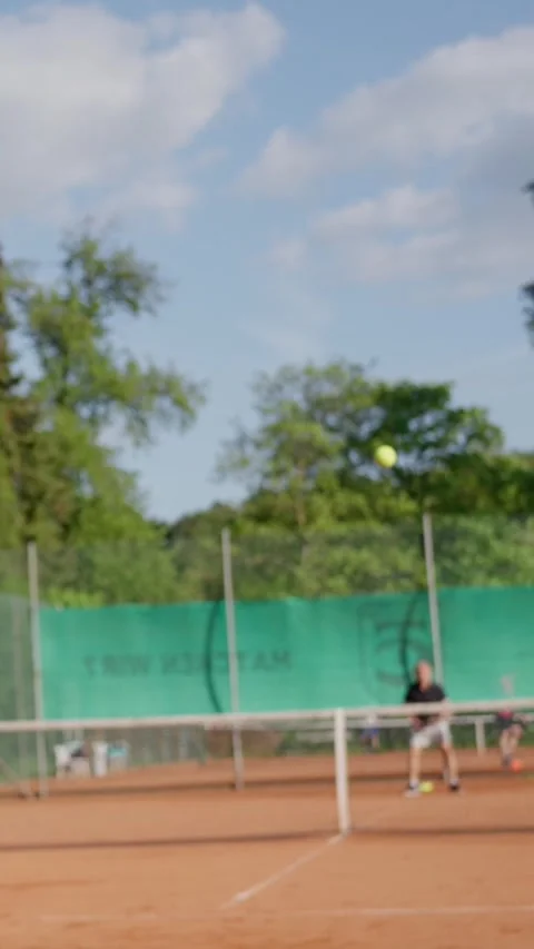 Close up of tennis racket hitting ball. A female tennis player skillfully Stock Footage 315519983