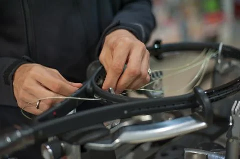 Close up of tennis stringer hands doing racket stringing Stock Photos