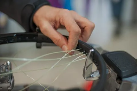 Close up of tennis stringer hands doing racket stringing Stock Photos
